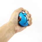 A hand squeezing TheMoodease Calming Smiley Blue Stress Ball for stress relief